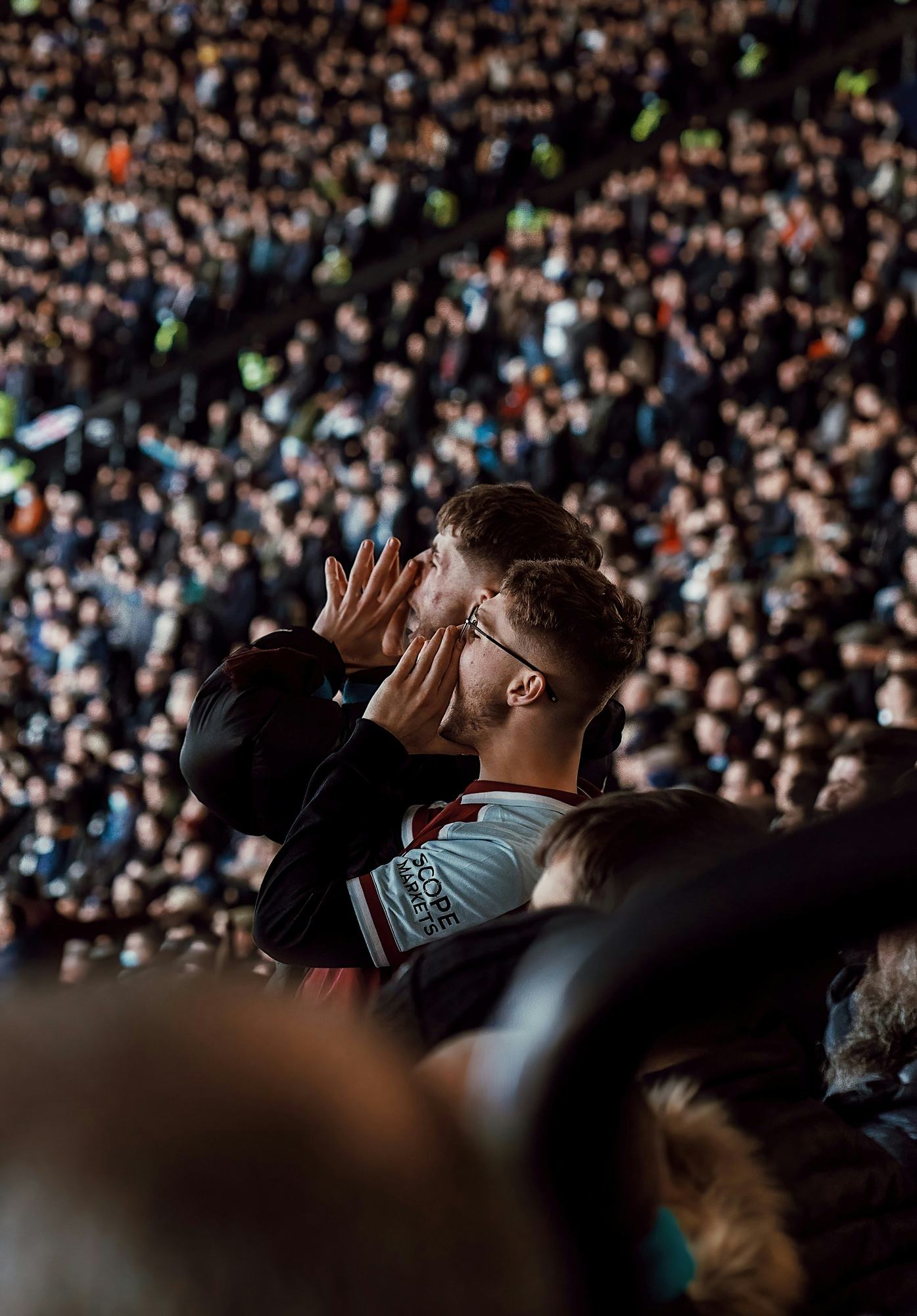 A supporter cupping his hands to shout from the crowd
